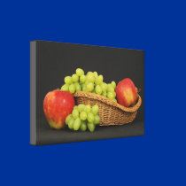 Basket with fruits on dark table canvas prints