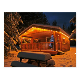 Beautiful Christmas Lights on Log Cabin in Snow Postcard