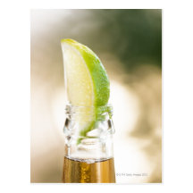 Beer bottle with lime wedge post cards