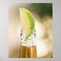 Beer bottle with lime wedge posters