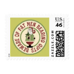 0 - This Christmas graphic features Santa Claus holding a Christmas tree, with the funny caption, Beware Of Fat Men Bearing Gifts.: Sizes  Available colors: 0