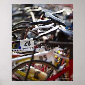 Bicycles on the rack at a triathlon race ready poster