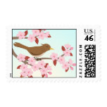 Bird sitting in a cherry blossom tree postage