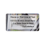 Black alpine goat doe waiting at metal gate personalized address label
