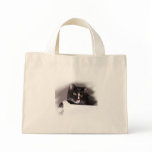 Black and white cat big yellow eyes looking right tote bag