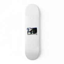 Black and white cat , santa hat, tinsel and a paw skate board decks