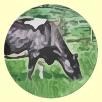 Black and white cow grazing painting. plates