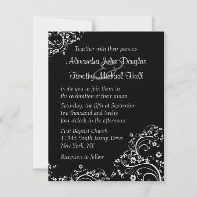 This wedding invitation has a black background with white floral swirlys on