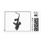 Black and white saxophone and two hands postage stamp