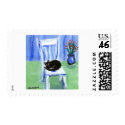 Black cat naps on chair postage