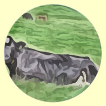 Black cow resting in grass painting plates
