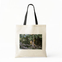 Black-headed grosbeak perched on tree limb tote bag