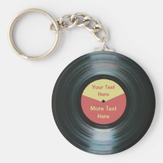 A keychain with a gramophone record design featuring the image of a vinyl or phonograph record from the era of the record player.