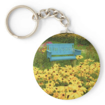 Blue bench in a field of  yellow black-eye Susans. Key Chains