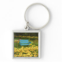 Blue bench in a field of  yellow black-eye Susans. Key Chain