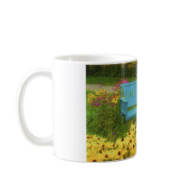 Blue bench in a field of  yellow black-eye Susans. Mug