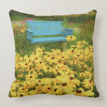 Blue bench in a field of  yellow black-eye Susans. Throw Pillows