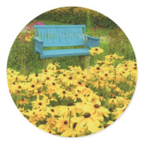 Blue bench in a field of  yellow black-eye Susans. Sticker