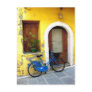 Blue bicycle against a yellow wall post cards