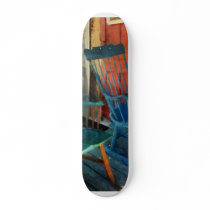 Blue Chair Against Red Door Skateboard Deck