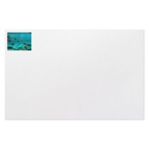 Blue pool of cichlids swimming around design stationery paper