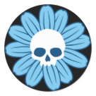 round_sticker - This cute gothy daisy has a skull in the center of light blue petals.