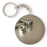 Bolts and nuts on metal surface keychain