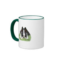 Boston terrier puppy resting coffee mug