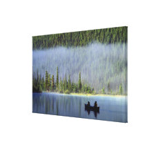 Boys fishing from canoe with mist in stretched canvas print