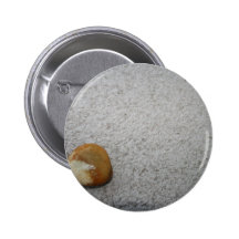 Brown and white round rock on cream carpet button