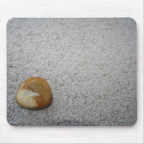 Brown and white round rock on cream carpet mouse pad