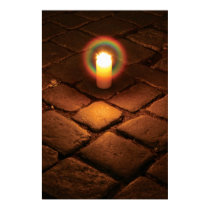 Candle on pavement posters