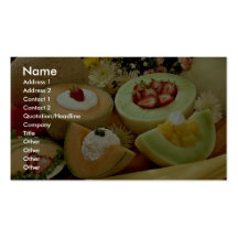 Cantaloupes and melons on cutting board with flowe business card