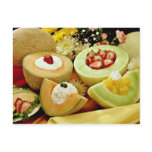 Cantaloupes and melons on cutting board with flowe postcard