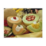 Cantaloupes and melons on cutting board with flowe postcard