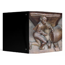 Carving depicting a man putting a tap on barrel vinyl binders
