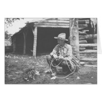 Cat eating out of a coffee can with a cowboy watch cards