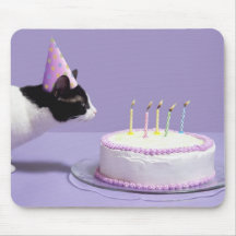 Cat wearing birthday hat blowing out candles on mouse pad