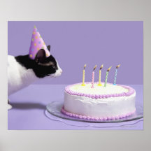 Cat wearing birthday hat blowing out candles posters