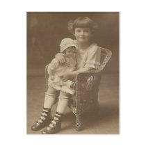 child sitting in chair holding doll post card