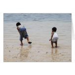 Children playing on the beach greeting card
