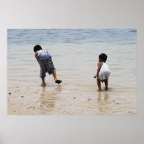 Children playing on the beach posters