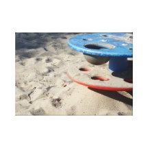 Child's toy in the sand stretched canvas print