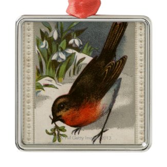 Circa 1871: A robin, with mistletoe in its beak Ornament