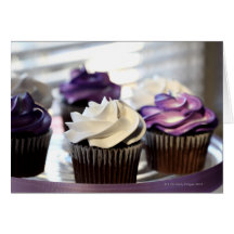 Close-up of cupcakes with selective focus on greeting cards