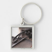 close-up of hand holding reins of horse keychains