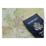 Close-up of passport lying on European map Card