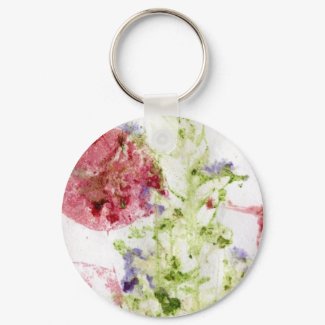 Close up of smashed flowers purple green red keychain