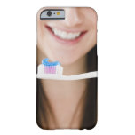 Close-up of smiling young woman holding barely there iPhone 6 case