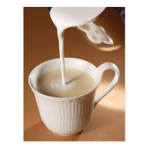 Coffee with milk being poured in post card